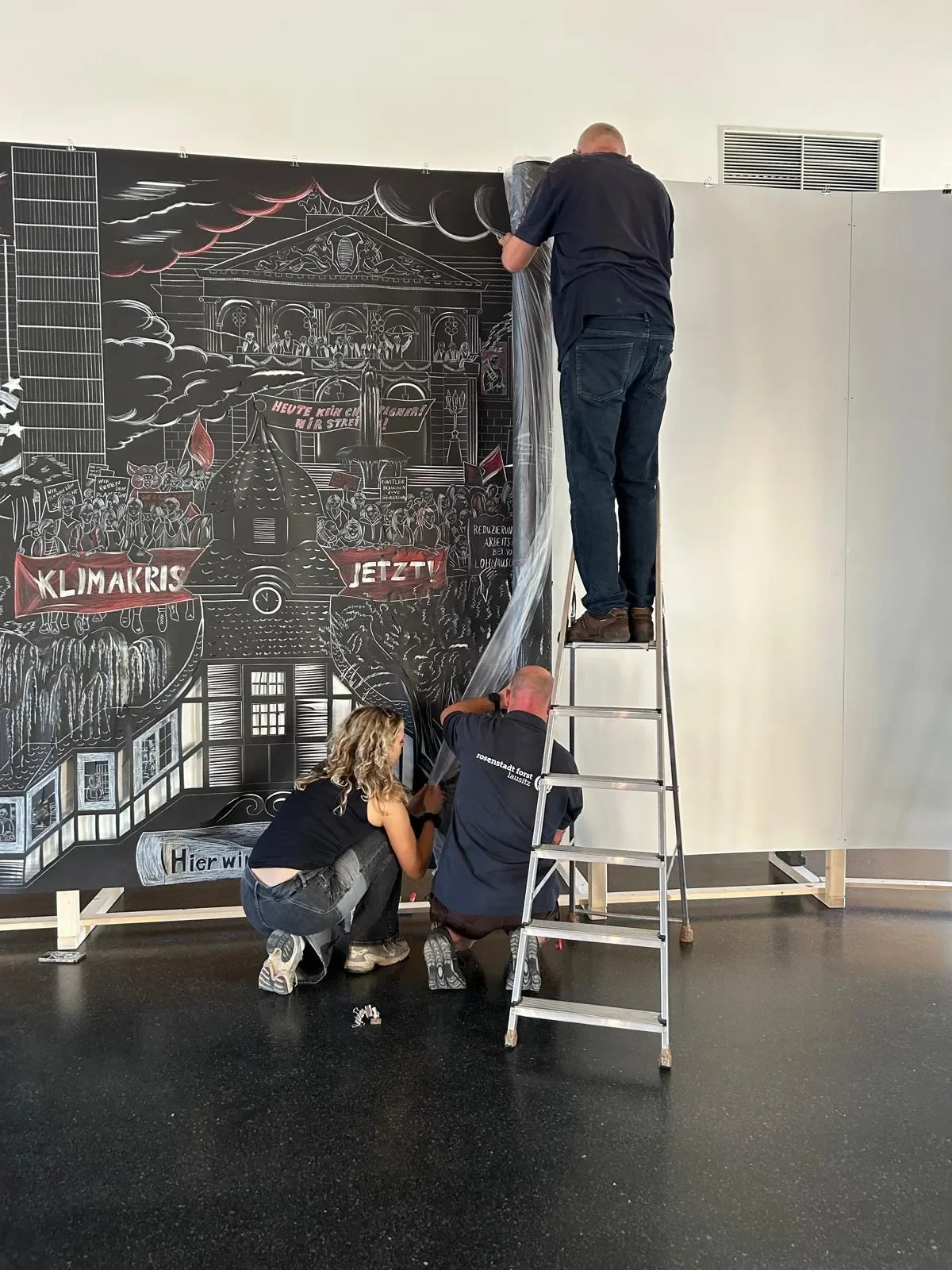 people setting up an exhibition