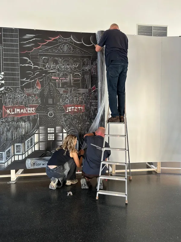 people setting up an exhibition